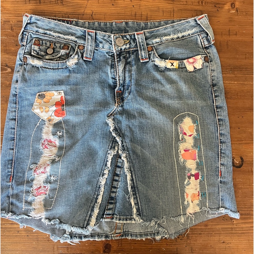 True Religion Denim Skirt.  Fringed edges with cut outs and patch work. WAIST 31